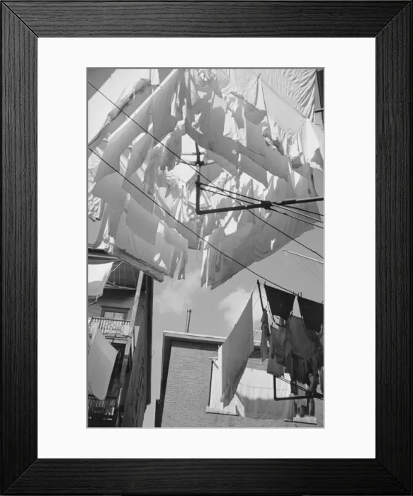 Framed Print : Family wash is heavy in this tenement section of the French Framed Print : Family wash is heavy in this tenement section of the French