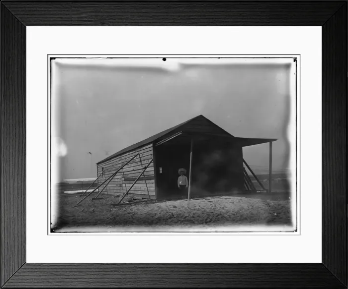 Framed Print : Tom Tate in front of camp building at Kitty Hawk, North Caro Framed Print : Tom Tate in front of camp building at Kitty Hawk, North Caro