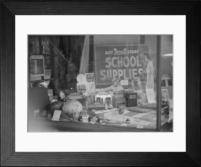 Framed Print : Vegetables (at left) and school supplies in drug store windo Framed Print : Vegetables (at left) and school supplies in drug store windo