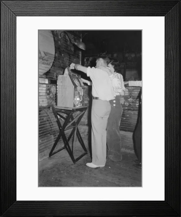 Framed Print : Couple playing slot machine, Raceland, Louisiana Framed Print : Couple playing slot machine, Raceland, Louisiana