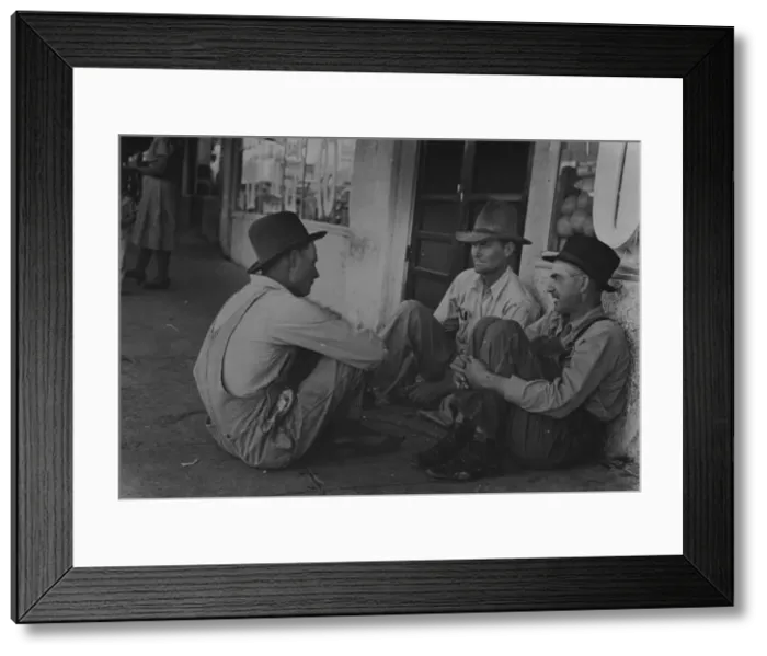 Framed Print : Farmers sitting aginst wall and squatting on sidewalk. Spur