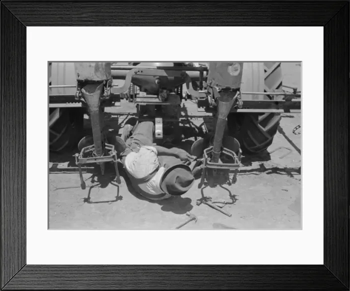 Framed Print : Adjusting plow points on tractor-drawn planter, large farm n Framed Print : Adjusting plow points on tractor-drawn planter, large farm n