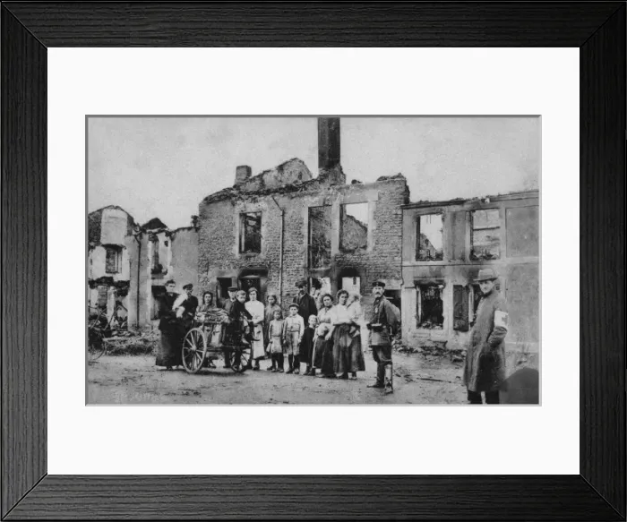 Framed Print : A French family stand outside their ruined home Framed Print : A French family stand outside their ruined home