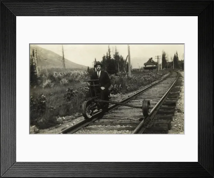Framed Print : A man sitting on part of a modified railway suspension Framed Print : A man sitting on part of a modified railway suspension