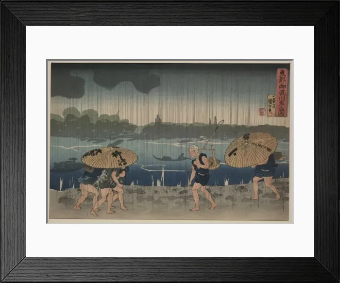 Framed Print : People walking beneath umbrellas along the seashore during a Framed Print : People walking beneath umbrellas along the seashore during a