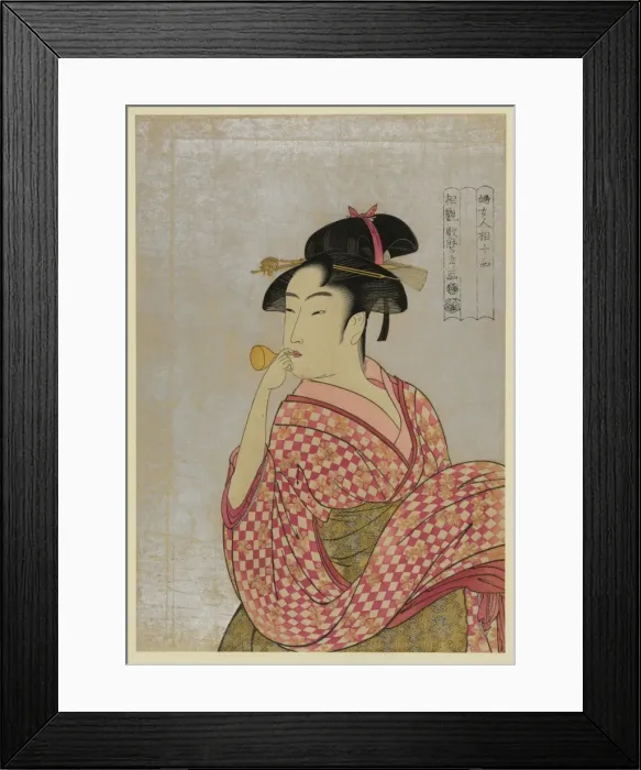 Framed Print : Young lady blowing on a poppin Framed Print : Young lady blowing on a poppin