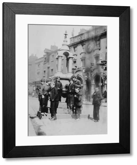 Framed Print : Slum life. Slum Life, boys around fountain, 1892 Date: 1892 Framed Print : Slum life. Slum Life, boys around fountain, 1892 Date: 1892