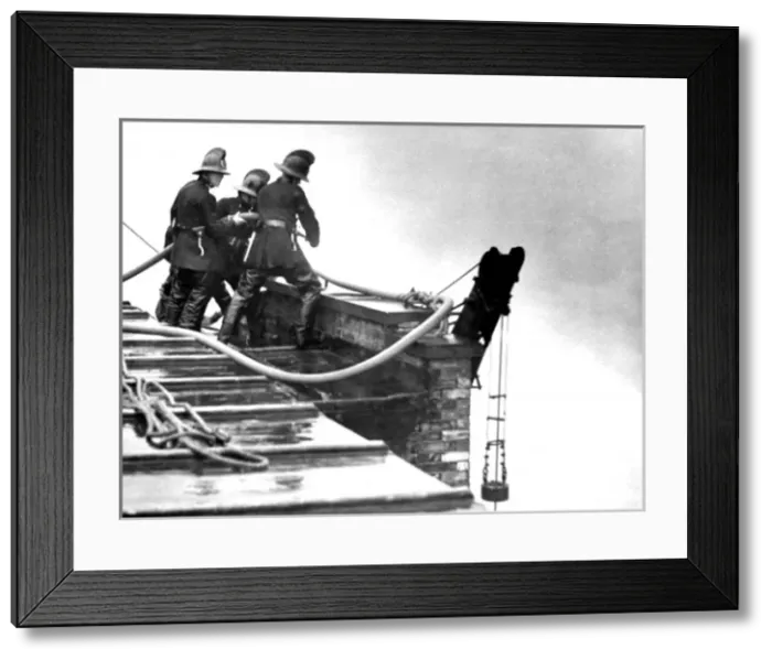 Framed Print : LFB firefighters working on a roof at a warehouse fire Framed Print : LFB firefighters working on a roof at a warehouse fire