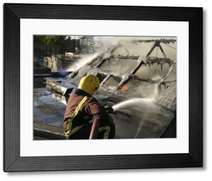 Framed Print : Firefighter working at scene of fire, New Cross Framed Print : Firefighter working at scene of fire, New Cross