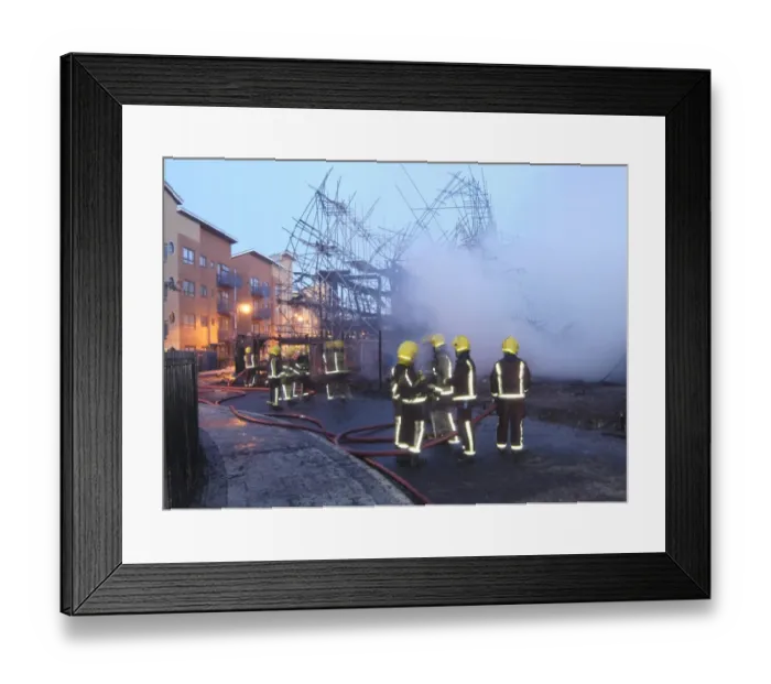 Framed Print : Firefighters working at fire on building site Framed Print : Firefighters working at fire on building site