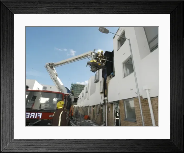 Framed Print : A hydraulic lift vehicle at the scene of a fire Framed Print : A hydraulic lift vehicle at the scene of a fire