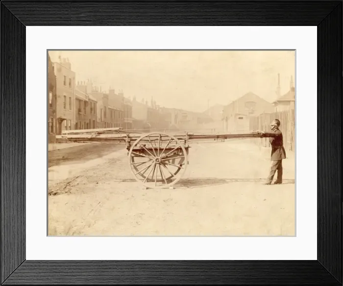 Framed Print : A firefighter with a wheeled ladder escape Framed Print : A firefighter with a wheeled ladder escape