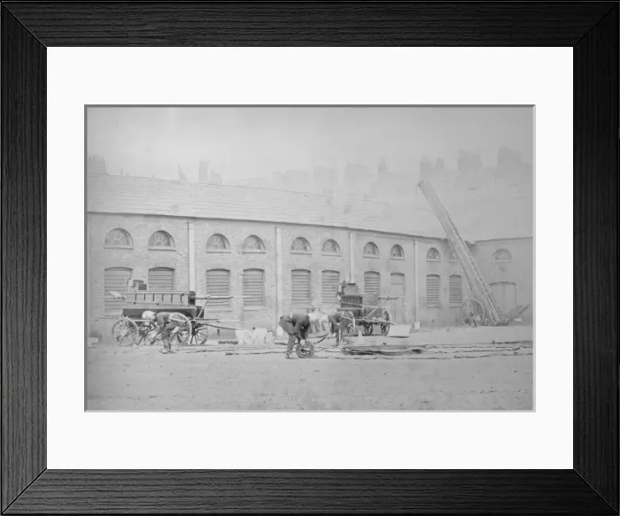 Framed Print : Firefighters winding up their hoses Framed Print : Firefighters winding up their hoses