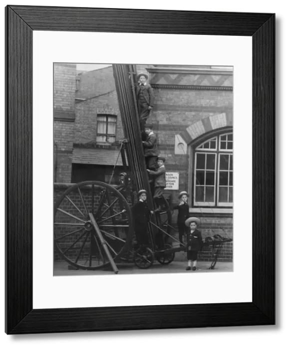 Framed Print : Children climbing up a wheeled escape ladder Framed Print : Children climbing up a wheeled escape ladder
