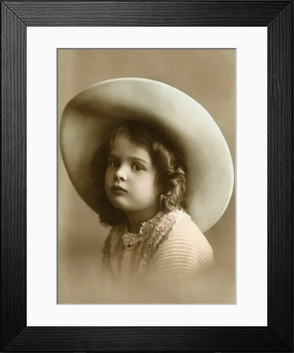 Framed Print : A sweet little girl wearing a wide-brimmed hat Framed Print : A sweet little girl wearing a wide-brimmed hat