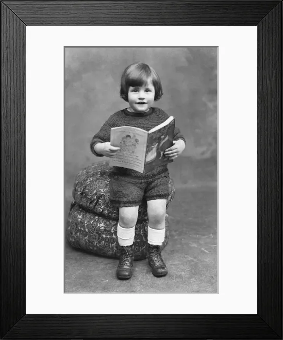 Framed Print : Sweet little boy reading a childrens magazine Framed Print : Sweet little boy reading a childrens magazine