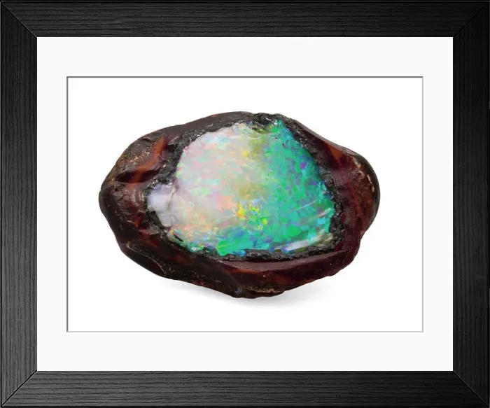 Framed Print : Opal in its natural form. The boulder has been split open to reveal the Framed Print : Opal in its natural form. The boulder has been split open to reveal the