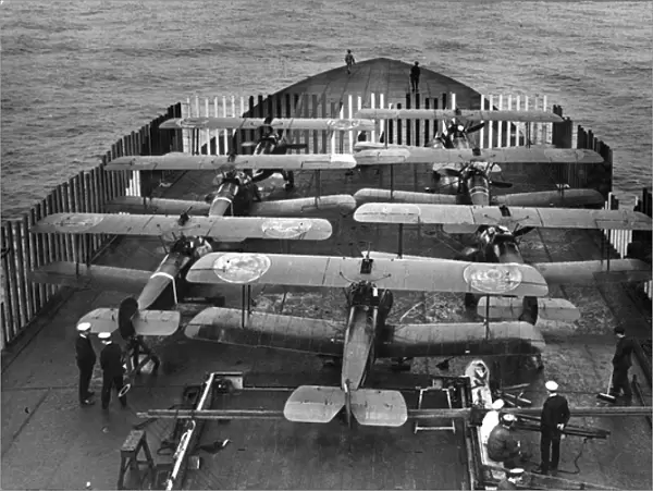 Seven Sopwith 2F1 Camels lined up on the deck of HMS Furious