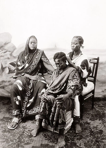 1900 Zanzibar - woman having her hair braided
