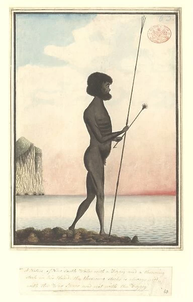Aboriginal man equipped for fishing, standing by the sea