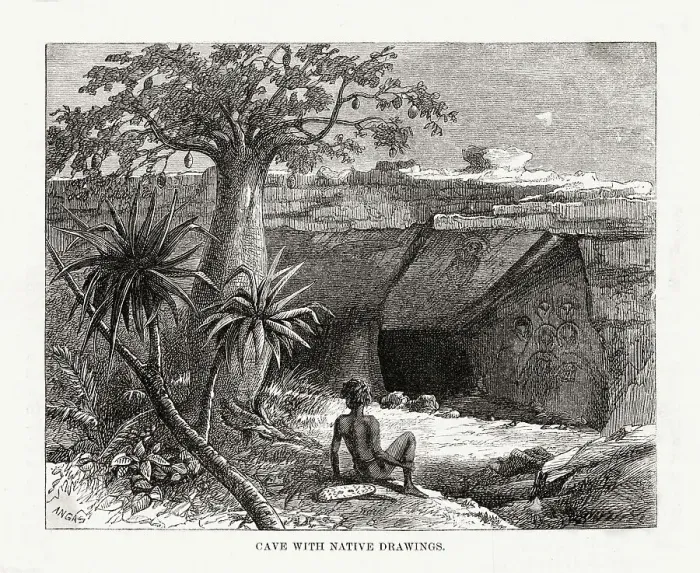 Framed Print : An aboriginal outside the entrance to a cave which is ornamented with religious artworks Date: circa 1860 Framed Print : An aboriginal outside the entrance to a cave which is ornamented with religious artworks Date: circa 1860