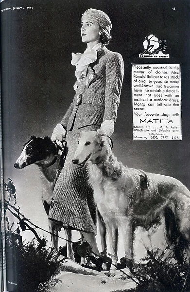 Advertisement for Matita Ltd, clothing, with Mrs Balfour and two lurchers, fashion studio portrait. With description, Pleasantly assured in the matter of clothes, Mrs Ronald Balfour takes stock for another year