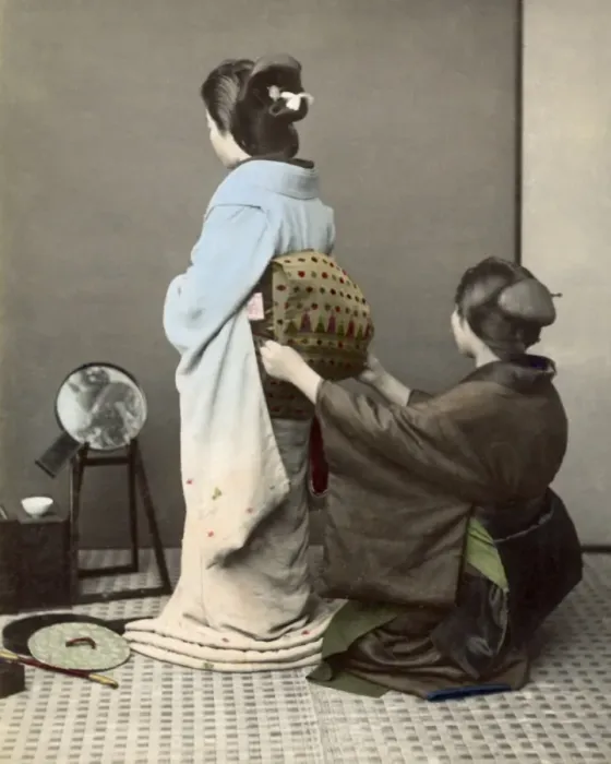 Framed Print : Adjusting an obi sash, Japan Framed Print : Adjusting an obi sash, Japan