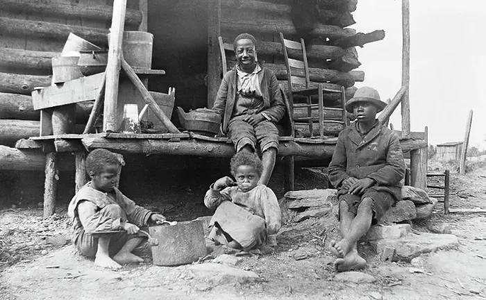 Framed Print : African-American children outside a log cabin in America Framed Print : African-American children outside a log cabin in America