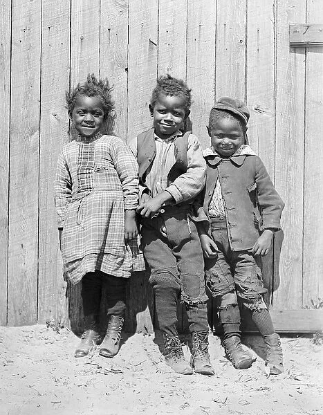 Three African American children smiling together in America