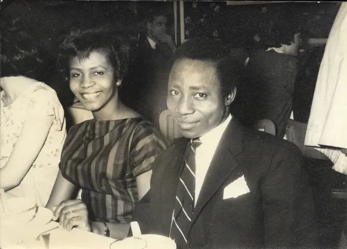 Framed Print : African couple, smiling at the camera at a dinner at the Con Framed Print : African couple, smiling at the camera at a dinner at the Con