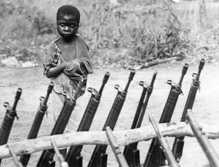 Framed Print : African orphan behind weapons Framed Print : African orphan behind weapons