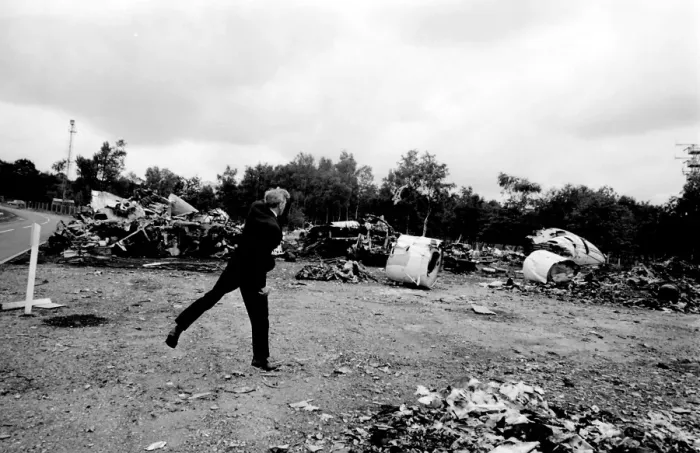 Framed Print : Air crash investigator examining debris