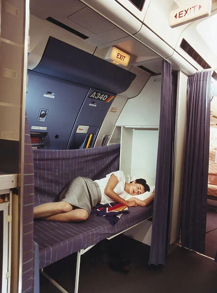 Airbus A340 Main Deck Cabin Crew Rest Option with a Stewardess Sleeping on a Bed Date