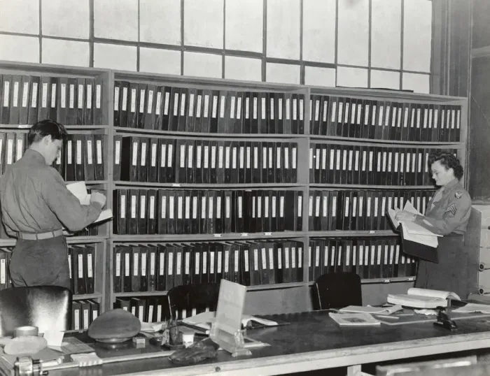 Framed Print : An Airman and Woman in the Office of the Headquarters of? Framed Print : An Airman and Woman in the Office of the Headquarters of?