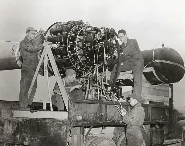 Airmen Working on a Jet Engine Mounted on a Special Fram?