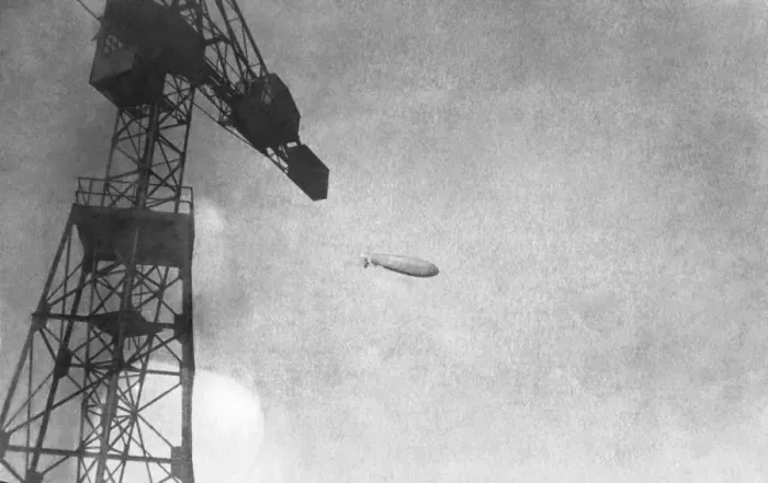 Framed Print : Airship Flying Past a Crane Framed Print : Airship Flying Past a Crane
