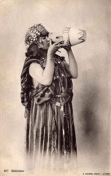 Algerian Bedouin Woman drinking from a small decorated ewer