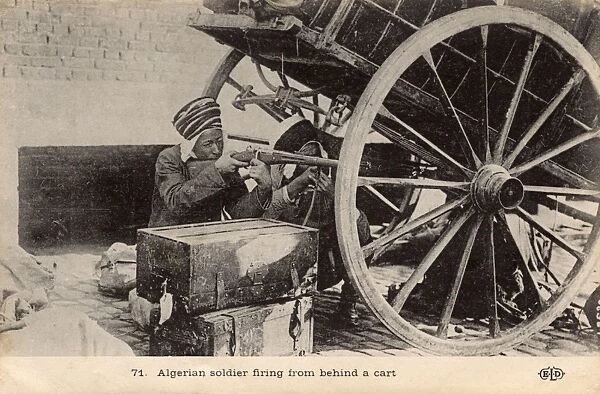 Two Algerian soldiers firing from behind the cover of a cart