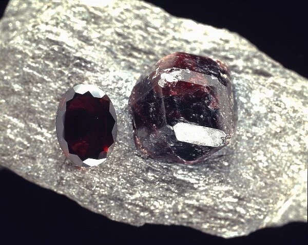 Almandite. A crystal and a cut stone of almandite, a deep red garnet comprised of 