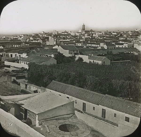 Alqesivas - Black and white view over low houses, spire right background Date: circa 1890s