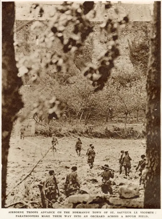 Framed Print : American airborne troops advancing through an orchard to the town of St Framed Print : American airborne troops advancing through an orchard to the town of St