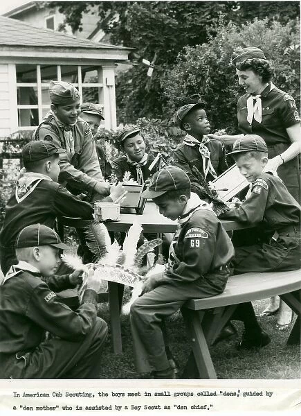 American Cub Scouts. A group of American cub scouts sit around a table doing art