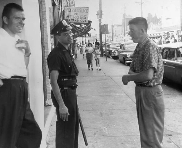 American Policeman. A cop reluctantly has his picture taken whilst on duty outside a bar