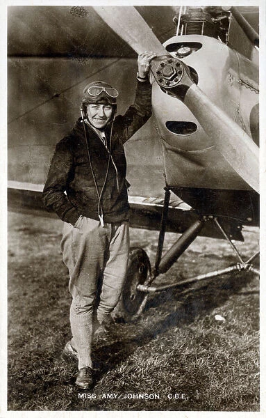 Amy Johnson CBE (1903-1941) - pioneering English female pilot - pictured standing in