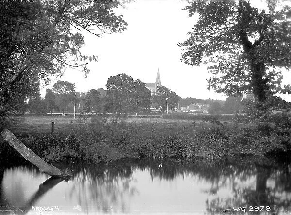 Armagh - a view over water to the city in the distance, only a Church spire
