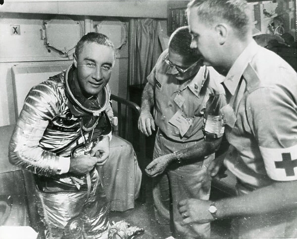 Astronaut Virgil ?Gus? Grissom starts to remove his spa?
