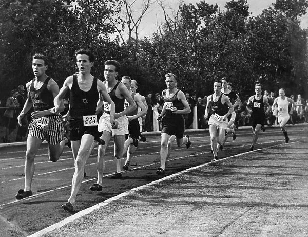 Athletics event with men on a race track