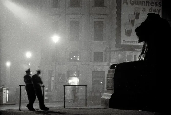 Framed Print : Atmospheric shot of two policement in silhouette resting in Trafalgar Square in front of giant lion statue Date: early 1950s Framed Print : Atmospheric shot of two policement in silhouette resting in Trafalgar Square in front of giant lion statue Date: early 1950s