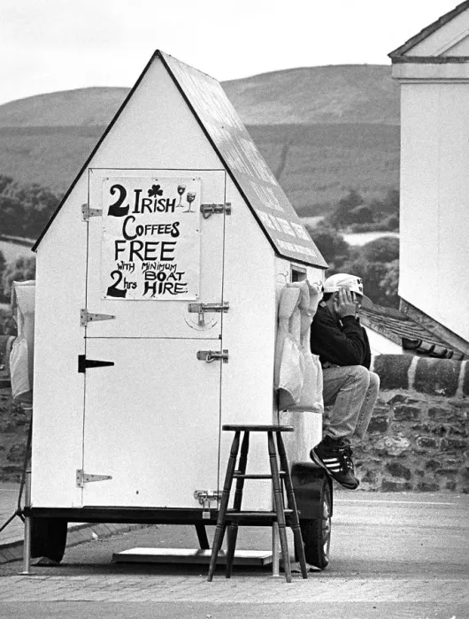 Framed Print : Attendant sits on mobile Boat Hire ticket office, Killaloe Framed Print : Attendant sits on mobile Boat Hire ticket office, Killaloe