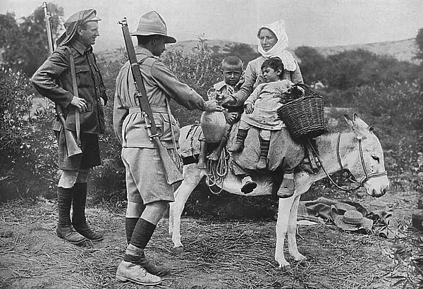 Australian soldiers giving water to local children, Dardanel